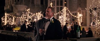 Movie still from “The Vow” (2012), directed by Michael Sucsy – A man in a tuxedo holding a glass of wine; Medium shot, Over the shoulder angle