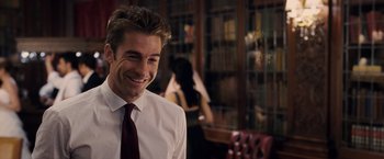 Movie still from “The Vow” (2012), directed by Michael Sucsy – A man in white shirt and red tie smiling; Medium shot, Over the shoulder angle