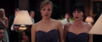 Movie still from “The Vow” (2012), directed by Michael Sucsy – A woman in a strapless purple dress looking into the camera; Close Up shot, Over the shoulder angle