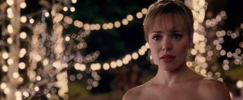 Movie still from “The Vow” (2012), directed by Michael Sucsy – A beautiful woman standing in front of a string of lights; Close Up shot, Over the shoulder angle