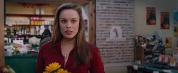 Movie still from “The Vow” (2012), directed by Michael Sucsy – A beautiful woman holding a bouquet of yellow flowers; Close Up shot, Over the shoulder angle