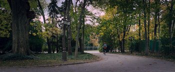 Movie still from “The Vow” (2012), directed by Michael Sucsy – A man riding a bike down a path in the woods; Extreme Wide shot, High angle