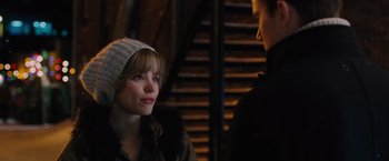 Movie still from “The Vow” (2012), directed by Michael Sucsy – A woman wearing a white hat and a brown jacket; Close Up shot, Over the shoulder angle