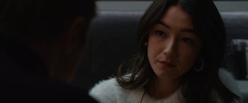 A woman sitting in front of a man in a car