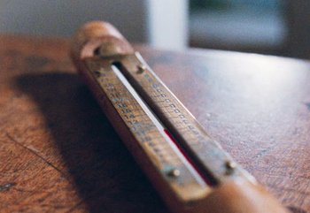 Movie still from “Enys Men” (2022), directed by Mark Jenkin – A ruler on top of a wooden table; Extreme Close Up shot, High angle