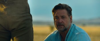 Movie still from “The Water Diviner” (2014), directed by Russell Crowe – A person wearing a blue shirt; Close Up shot, Over the shoulder angle