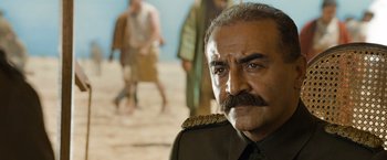 Movie still from “The Water Diviner” (2014), directed by Russell Crowe – An older man with a mustache wearing a military uniform; Close Up shot, Low angle