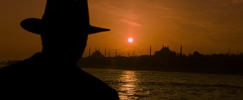 Movie still from “The Water Diviner” (2014), directed by Russell Crowe – The sun is setting over the water and the city skyline; Extreme Wide shot, Low angle