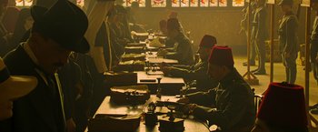 Movie still from “The Water Diviner” (2014), directed by Russell Crowe – A group of men sitting at a long wooden table; Wide shot, High angle