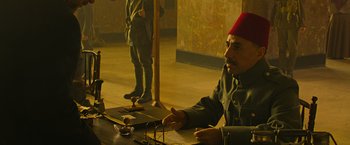 Movie still from “The Water Diviner” (2014), directed by Russell Crowe – A man sitting at a table in front of a mirror; Medium shot, Over the shoulder angle