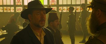 Movie still from “The Water Diviner” (2014), directed by Russell Crowe – A man in a hat and a suit is looking into the distance; Close Up shot, Over the shoulder angle