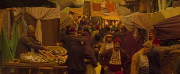 Movie still from “The Water Diviner” (2014), directed by Russell Crowe – A group of people standing in a market area; Wide shot, High angle