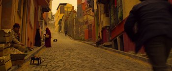 Movie still from “The Water Diviner” (2014), directed by Russell Crowe – A street scene with a person laying on the ground; Extreme Wide shot, High angle