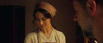 A woman wearing an apron and head covering