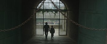 Movie still from “The Water Diviner” (2014), directed by Russell Crowe – A man and a child walking through a tunnel; Wide shot, Low angle
