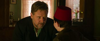 Movie still from “The Water Diviner” (2014), directed by Russell Crowe – A man talking to a young boy wearing a red hat; Close Up shot, Over the shoulder angle