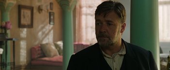 Movie still from “The Water Diviner” (2014), directed by Russell Crowe – A person wearing a suit and tie; Close Up shot, Over the shoulder angle