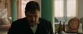 Movie still from “The Water Diviner” (2014), directed by Russell Crowe – A person wearing a suit and tie; Close Up shot, Over the shoulder angle