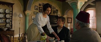 Movie still from “The Water Diviner” (2014), directed by Russell Crowe – A man and a woman standing at a dinner table; Medium shot, Low angle