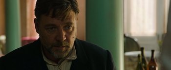 Movie still from “The Water Diviner” (2014), directed by Russell Crowe – A person wearing a suit and tie; Close Up shot, Over the shoulder angle