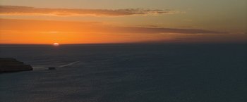 Movie still from “The Water Diviner” (2014), directed by Russell Crowe – An orange sky over a body of water at sunset; Extreme Wide shot, High angle