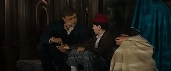 Movie still from “The Water Diviner” (2014), directed by Russell Crowe – A man and a boy sitting next to each other; Medium shot, Over the shoulder angle