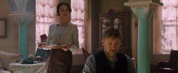 Movie still from “The Water Diviner” (2014), directed by Russell Crowe – A man and a woman are in a room; Medium shot, Low angle
