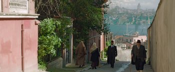 A group of people walking down a street