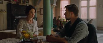 Movie still from “The Water Diviner” (2014), directed by Russell Crowe – A man and a woman are sitting at a table; Medium shot, Over the shoulder angle