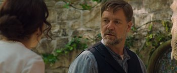 Movie still from “The Water Diviner” (2014), directed by Russell Crowe – A person wearing a vest near a stone wall; Close Up shot, Over the shoulder angle