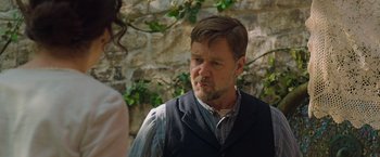 Movie still from “The Water Diviner” (2014), directed by Russell Crowe – A man wearing a vest and a plaid button up shirt; Close Up shot, Over the shoulder angle
