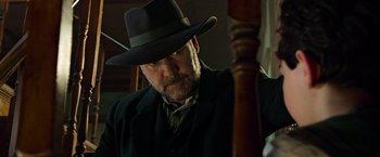 Movie still from “The Water Diviner” (2014), directed by Russell Crowe – A man wearing a hat and a suit; Close Up shot, Low angle
