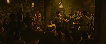 Movie still from “The Water Diviner” (2014), directed by Russell Crowe – A group of people sitting in a room; Wide shot, High angle