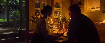 Movie still from “The Water Diviner” (2014), directed by Russell Crowe – A man and a woman sitting in front of candles; Medium shot, Over the shoulder angle