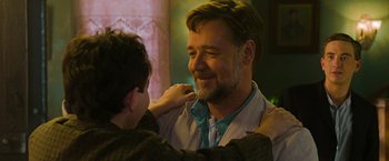 Movie still from “The Water Diviner” (2014), directed by Russell Crowe – A man is putting a tie on a young boy's neck; Close Up shot, Over the shoulder angle