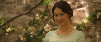 Movie still from “The Water Diviner” (2014), directed by Russell Crowe – A woman in a green dress standing in front of a tree; Close Up shot, Over the shoulder angle