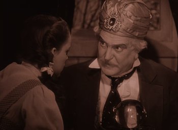 Movie still from “The Wizard of Oz” (1939), directed by Victor Fleming – An older man and a young woman are talking to each other; Close Up shot, Low angle
