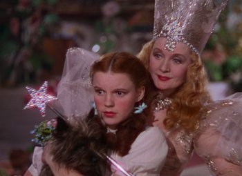 Movie still from “The Wizard of Oz” (1939), directed by Victor Fleming – Two women dressed up as glinda the good and the witch; Close Up shot, Low angle