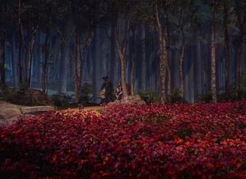 Movie still from “The Wizard of Oz” (1939), directed by Victor Fleming – A forest filled with red flowers and trees; Extreme Wide shot, High angle