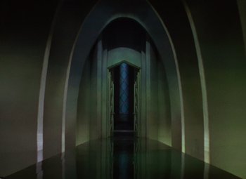 Movie still from “The Wizard of Oz” (1939), directed by Victor Fleming – An empty room with a mirror and a door; Extreme Wide shot, High angle