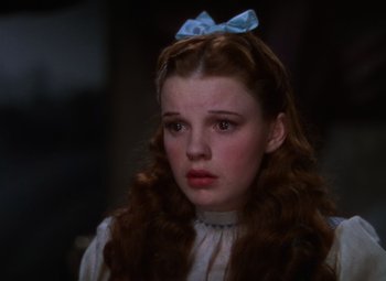 Movie still from “The Wizard of Oz” (1939), directed by Victor Fleming – A person with long brown hair; Close Up shot, Low angle