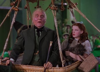 Movie still from “The Wizard of Oz” (1939), directed by Victor Fleming – A man and a woman are in a basket; Wide shot, Low angle