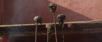 Movie still from “The Woman King” (2022), directed by Gina Prince-Bythewood – A group of four skulls on top of a pole; Close Up shot, High angle