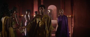 Movie still from “The Woman King” (2022), directed by Gina Prince-Bythewood – A group of people standing in a room; Medium shot, Low angle