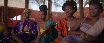 Movie still from “The Woman King” (2022), directed by Gina Prince-Bythewood – A group of women sitting next to each other; Medium shot, Low angle