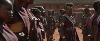 Movie still from “The Woman King” (2022), directed by Gina Prince-Bythewood – A group of people standing next to each other on a field; Medium shot, Over the shoulder angle