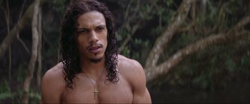 Movie still from “The Woman King” (2022), directed by Gina Prince-Bythewood – A person wearing a necklace; Close Up shot, Over the shoulder angle