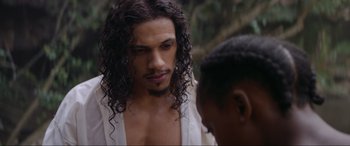 Movie still from “The Woman King” (2022), directed by Gina Prince-Bythewood – A person with long curly hair; Close Up shot, Over the shoulder angle