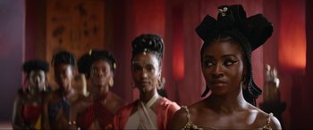 Movie still from “The Woman King” (2022), directed by Gina Prince-Bythewood – A group of women standing next to each other in a room; Close Up shot, Over the shoulder angle