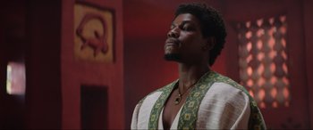 Movie still from “The Woman King” (2022), directed by Gina Prince-Bythewood – A man in a robe looking up at the ceiling; Close Up shot, Low angle